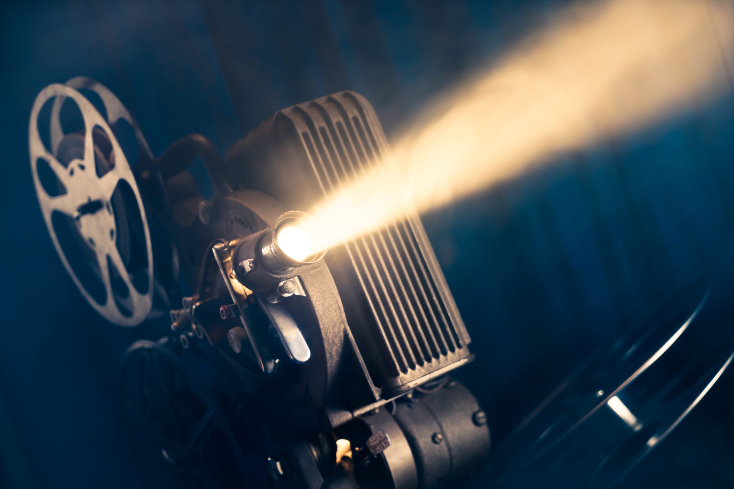 Film,Projector,On,A,Wooden,Background,With,Dramatic,Lighting,And